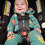 baby, child, car_seat, smiling, headband, yellow, green, floral, clothing, straps, safety, happy, infant, cute, portrait, seat, baby_clothes, indoor, child_seat, closeup