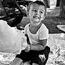 Liam a rejoint le concours — aidez-le/la à gagner de superbes lots ! black_and_white, blanket, boy, candid, child, cotton_candy, grass, happy, nature, outdoor, phone, playful, portrait, short_hair, shorts, sitting, smile, stroller, trees, tshirt