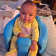 Amariana joined the competition — help win amazing prizes! baby, child, smiling, yellow_onesie, blue_baby_seat, infant, cute, happy, portrait, indoors, clothing, fabric, face, person, seat, baby_seat, hand, tongue, expression, home