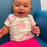 Amariana joined the competition — help win amazing prizes! baby, child, smiling, happy, sitting, shirt, pink_pants, strawberry_print, blue_chair, indoor, person, cute, infant, portrait, young_child, toddler, clothing, furniture, joyful, face