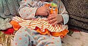Amariana joined the competition — help win amazing prizes! baby, blanket, bows, child, clothing, cozy, cushion, cute, face, footed_pajamas, grey, holiday, indoor, infant, orange, person, polka_dot, pumpkin, sitting, toy