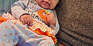 Amariana joined the competition — help win amazing prizes! baby, infant, couch, blanket, clothing, orange, gray, polka_dots, ribbons, face, person, smile, holiday, halloween, decor, home, cozy, soft, toddler, cute