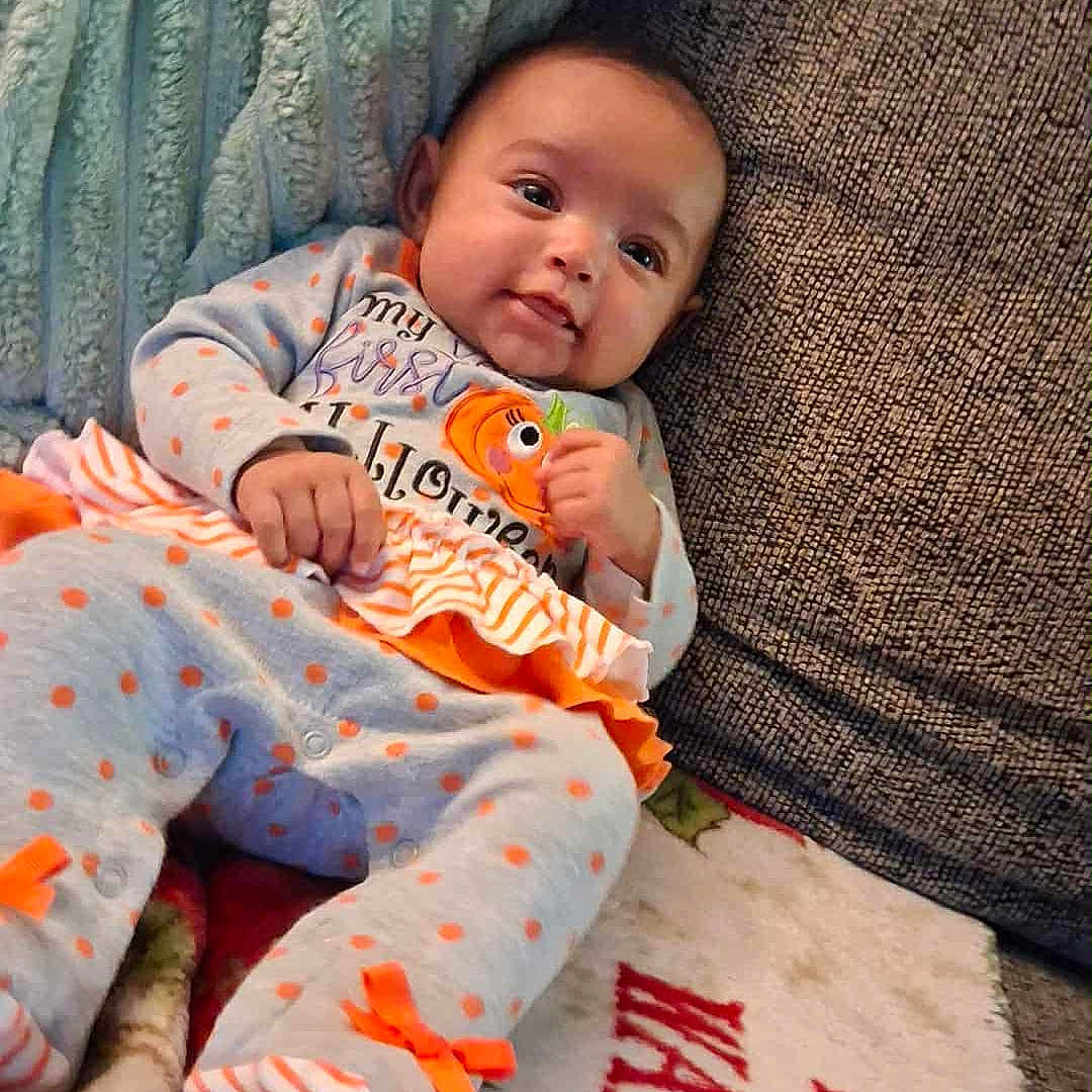 Amariana joined the competition — help win amazing prizes! baby, blanket, clothing, couch, cozy, cute, decor, face, gray, halloween, holiday, home, infant, orange, person, polka_dots, ribbons, smile, soft, toddler