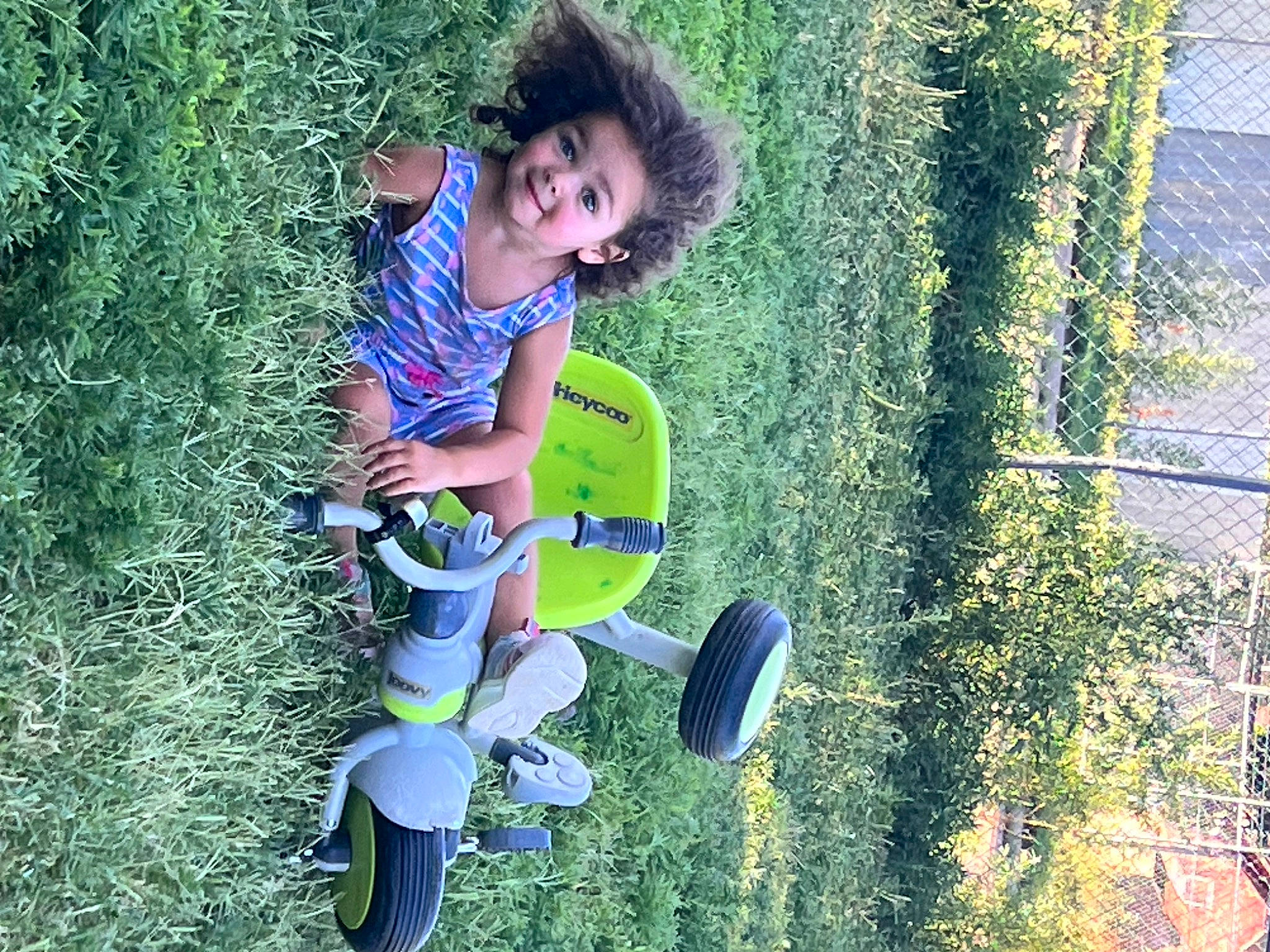 Eliza joined the competition — help win amazing prizes! electric_blue, extreme_sport, fun, garden, grass, grassland, happy, joy, lawn, leisure, people_in_nature, person, plant, recreation, shadow, shrub, sitting, soil, t_shirt, toddler