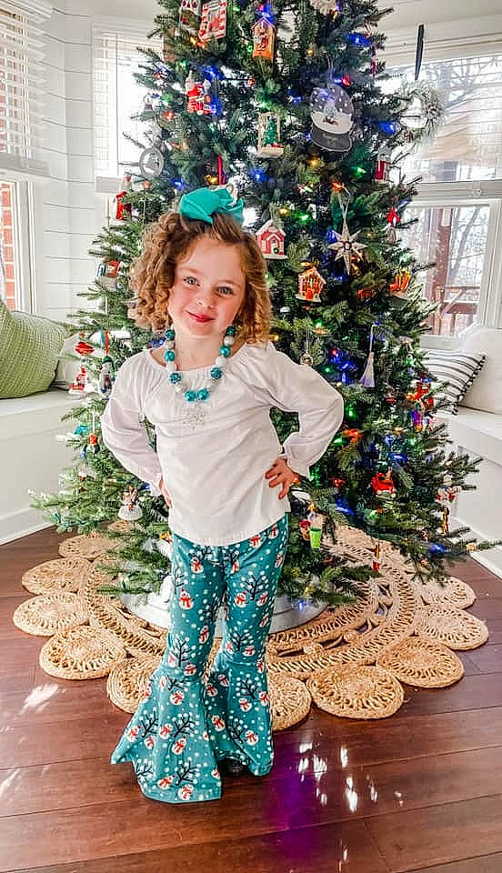 Raegan is registered to the contest to win money with this photo: branch, christmas, christmas_decoration, christmas_eve, christmas_ornament, christmas_tree, event, evergreen, green, happy, holiday, holiday_ornament, joy, ornament, person, plant, sleeve, smile, toddler, tree