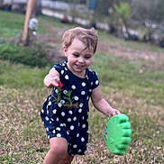 Kaleigh joined the competition — help win amazing prizes! toddler, child, grass, outdoor, toy, green, polka_dot, dress, barefoot, happy, smiling, nature, play, young_child, running, flower, short_sleeve, casual_clothing, daylight, blurred_background