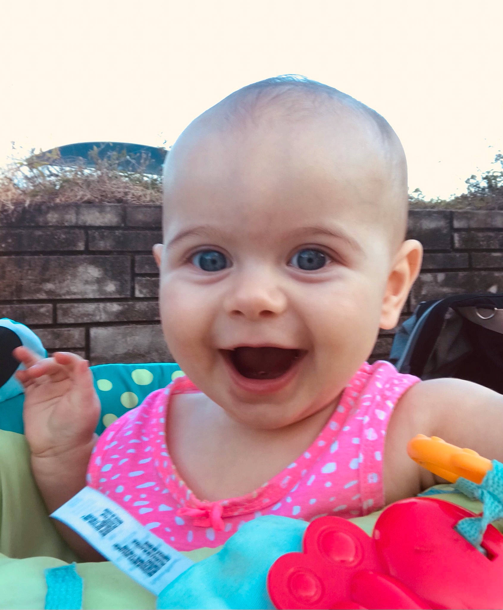 Lyanna is registered to the contest to win money with this photo: baby, baby_toddler_clothing, cheek, child, facial_expression, finger, fun, gesture, hand, happy, head, iris, lip, mouth, nose, person, pink, product, skin, smile