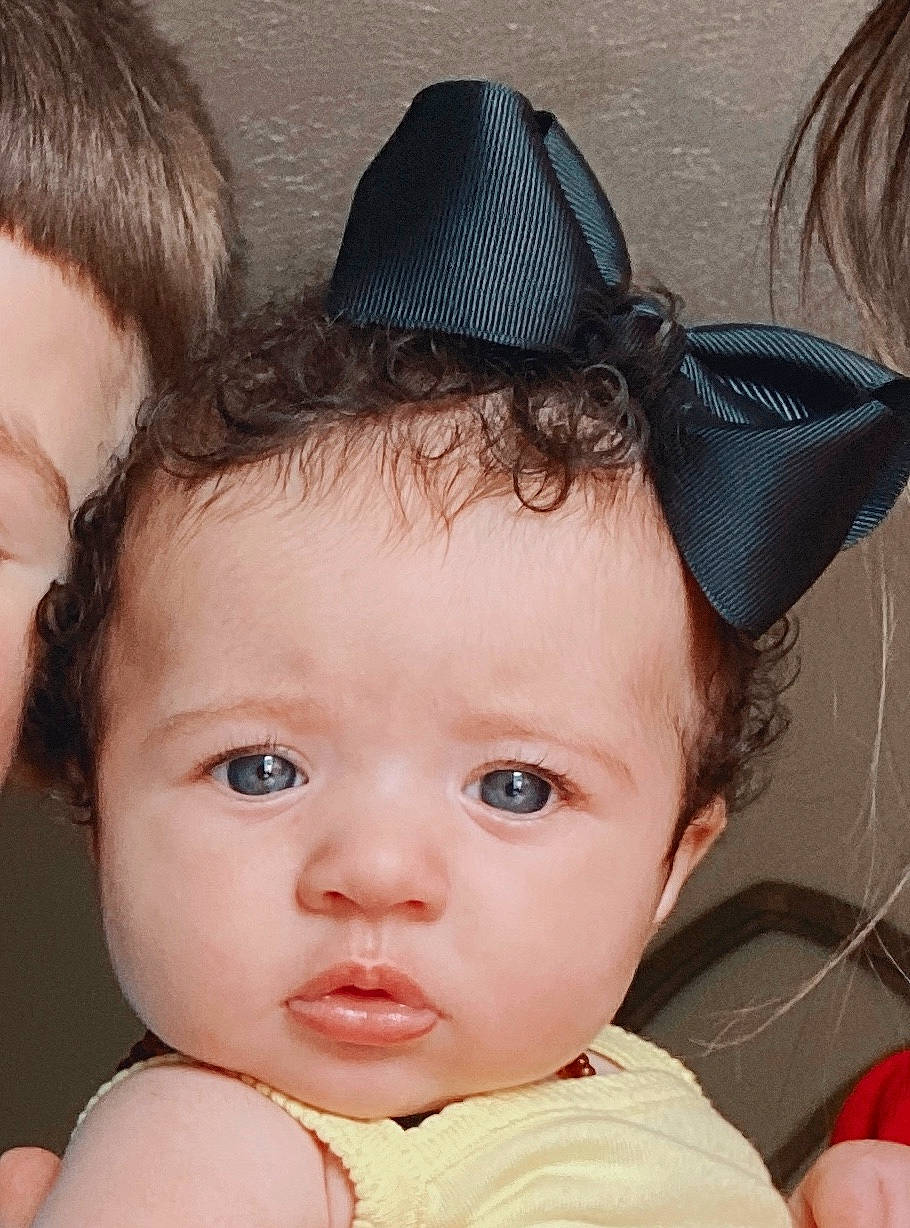 Rowyn is registered to the contest to win money with this photo: baby, black_hair, brown_hair, cheek, child, child_model, ear, face, fashion_accessory, forehead, hair, hair_accessory, hat, head, headgear, lip, person, skin, toddler