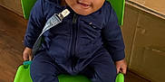 Navy joined the competition — help win amazing prizes! baby, child, infant, green_chair, navy_blue_clothing, gray_hat, socks, indoor, wooden_floor, cardboard_box, smiling, seated, cute, face, person, young_child, looking_up, happy, casual_wear, small_chair