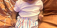 Te'Aari is registered to the contest to win money with this photo: baby, babylaughing, clothing, couch, cushion, face, footwear, furniture, happy, head, homedecor, laughing, person, photography, portrait, sandal, shorts, sitting, smile, t_shirt