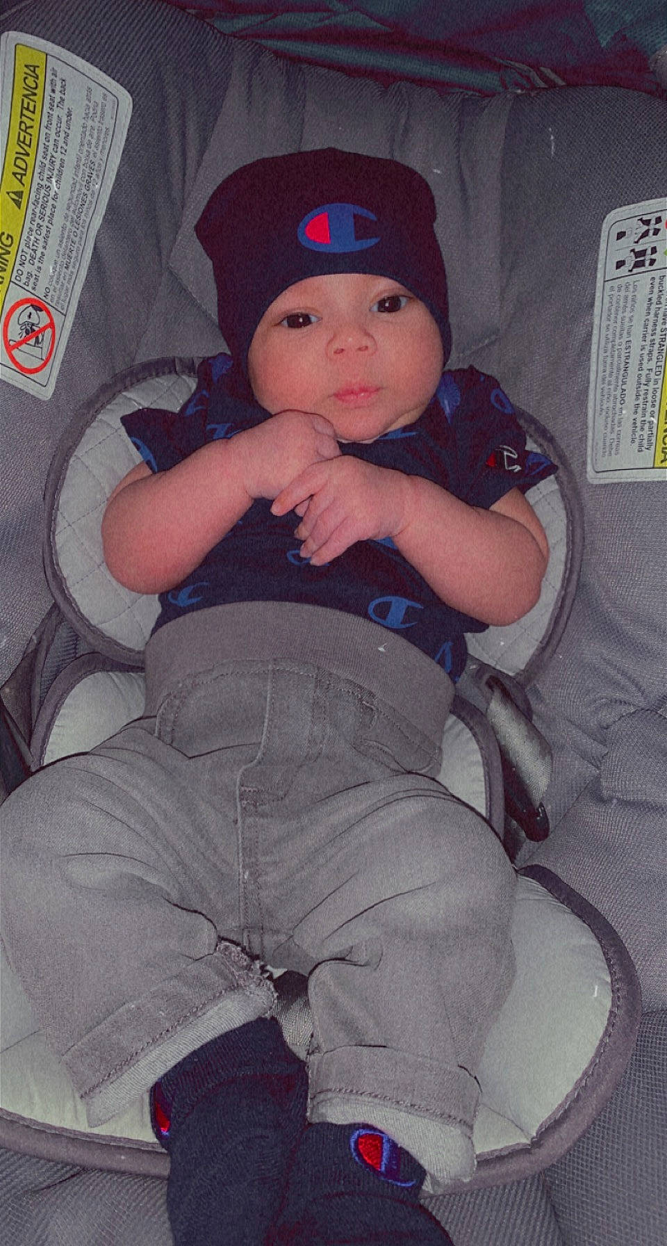 Dee is registered to the contest to win money with this photo: baby, baby_toddler_clothing, baseball_cap, cap, car_seat, cheek, comfort, cool, electric_blue, eye, hat, headwear, human_body, lap, person, pink, sitting, sleeve, smile, t_shirt