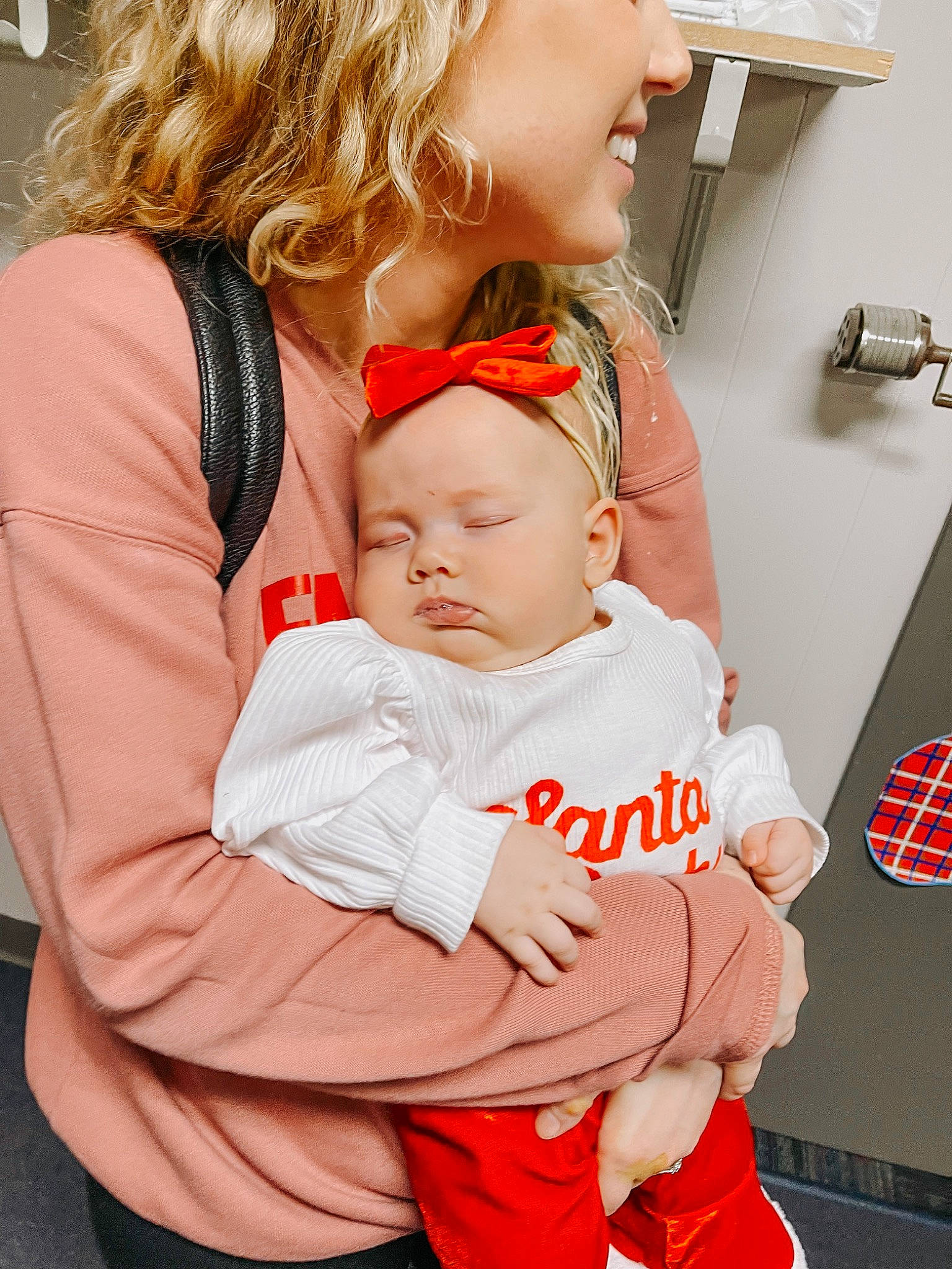 Bennett is registered to the contest to win money with this photo: arm, baby, baby_toddler_clothing, blond, cheek, child, comfort, event, finger, gesture, hand, happy, jewellery, lap, person, product, red, sitting, skin, sleeve