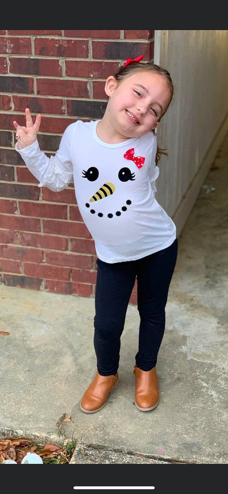 Ashlynn is registered to the contest to win money with this photo: arm, baby_toddler_clothing, brick, brickwork, cool, eye, face, flooring, gesture, happy, head, joint, joy, leg, neck, outerwear, person, sleeve, smile, standing