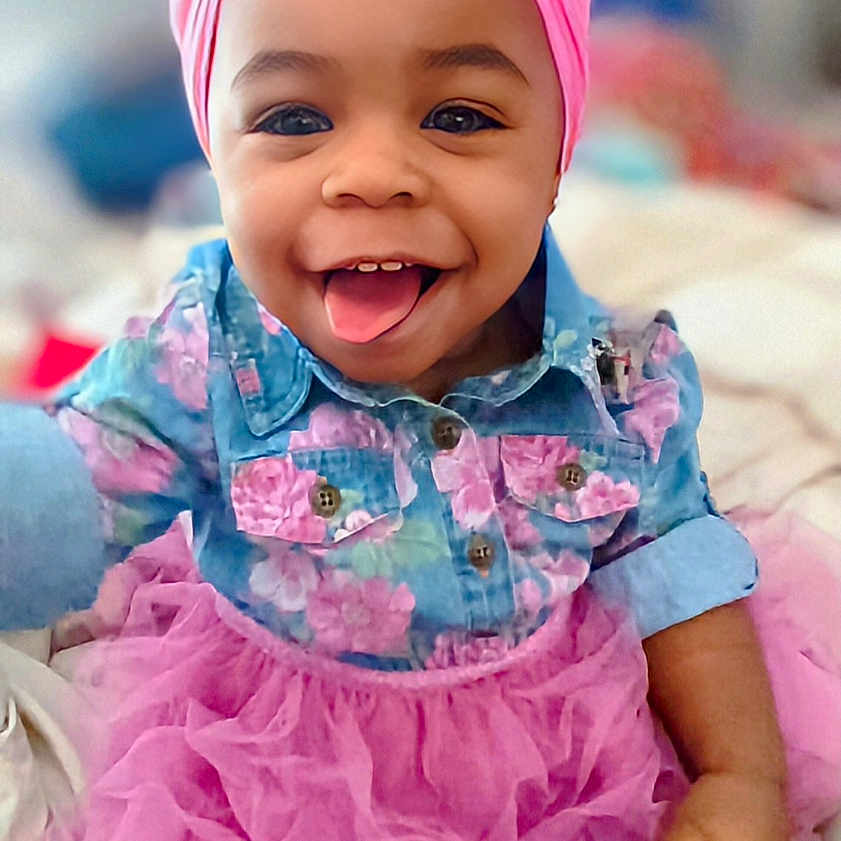 Julecia-Myçhél joined the competition — help win amazing prizes! baby, child, clothing, cute, denim, face, floral, happy, headband, indoor, infant, person, pink, playful, portrait, shirt, skirt, smiling, toddler, tongue_out