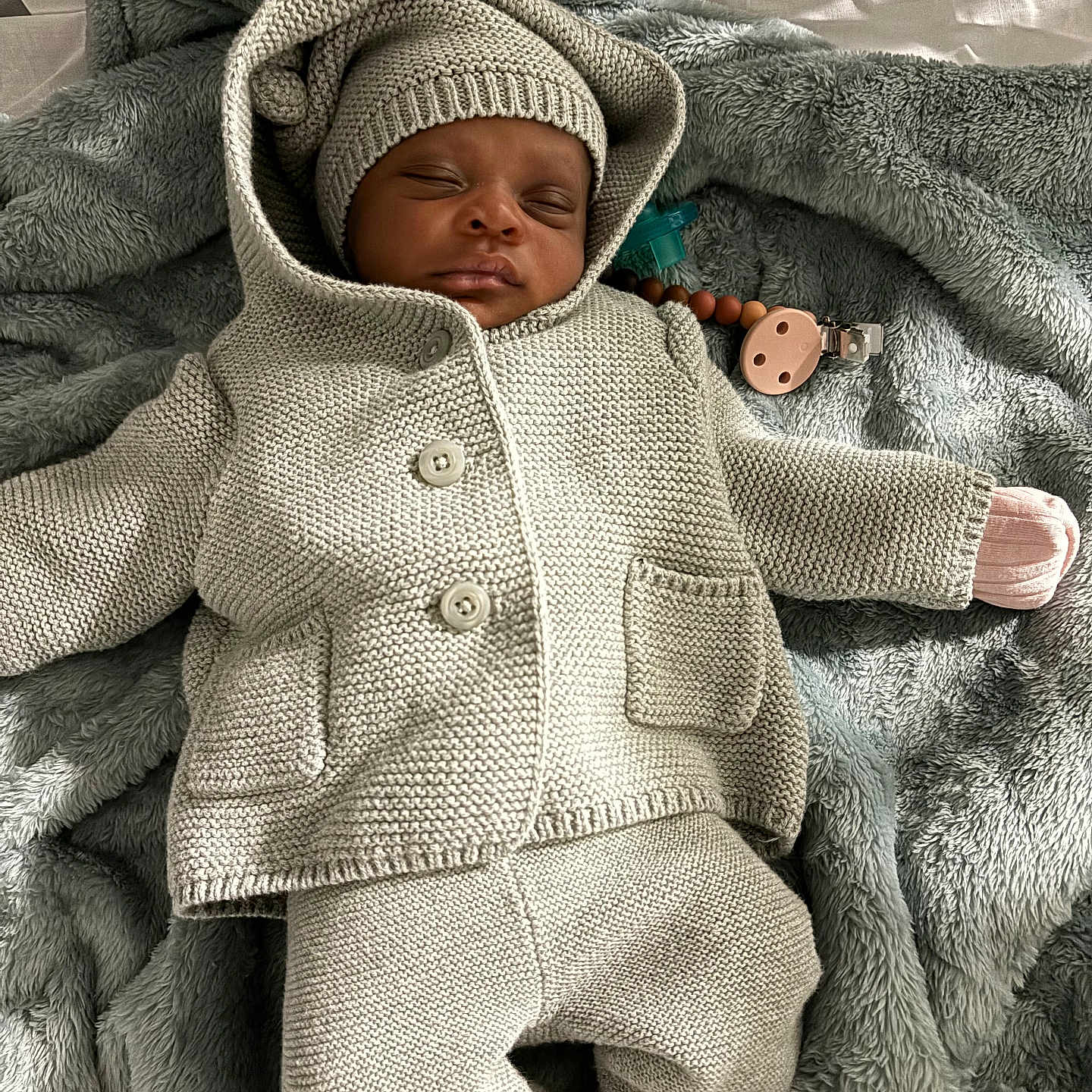 Kamyie is registered to the contest to win money with this photo: baby, bed, blanket, bonnet, cap, clothing, crib, face, furniture, hat, head, hood, hoodie, infantbed, knitwear, newborn, person, photography, portrait, sweater