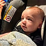 Malakai joined the competition — help win amazing prizes! baby, child, blanket, car_seat, car_interior, infant, face, person, hand, clothing, portrait, closeup, seatbelt, dashboard, speedometer, soft_lighting, young, cute, indoors, protection