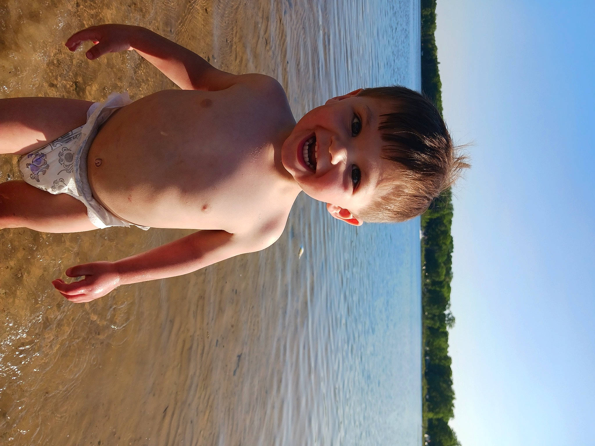 Franky is registered to the contest to win money with this photo: arm, barechested, beach, chest, elbow, flash_photography, fun, happy, lake, leisure, people_in_nature, people_on_beach, person, sky, smile, summer, sunlight, toddler, trunk, water