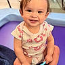 toddler, child, smiling, hair_bows, toothbrush, sitting, purple_mat, blanket, indoor, cute, happy, person, baby, clothing, playtime, face, skin, head, expression, young_child