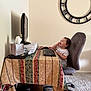 toddler, child, computer, keyboard, mouse, office_chair, tablecloth, tissue_box, wall_clock, carpet, desk, indoor, home_office, smiling, sitting, technology, furniture, person, happy, curly_hair