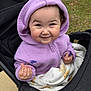 Sutton is registered to the contest to win money with this photo: toddler, child, hoodie, lavender, stroller, blanket, flower, purple, grass, outdoor, smile, happy, cute, baby, person, clothing, nature, hand, face, portrait