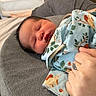 animal_pattern, baby, bed, blanket, child, cozy, cushion, cute, hand, indoor, infant, newborn, nursery, peaceful, portrait, resting, sleeping, soft_lighting, toddler, wrapped