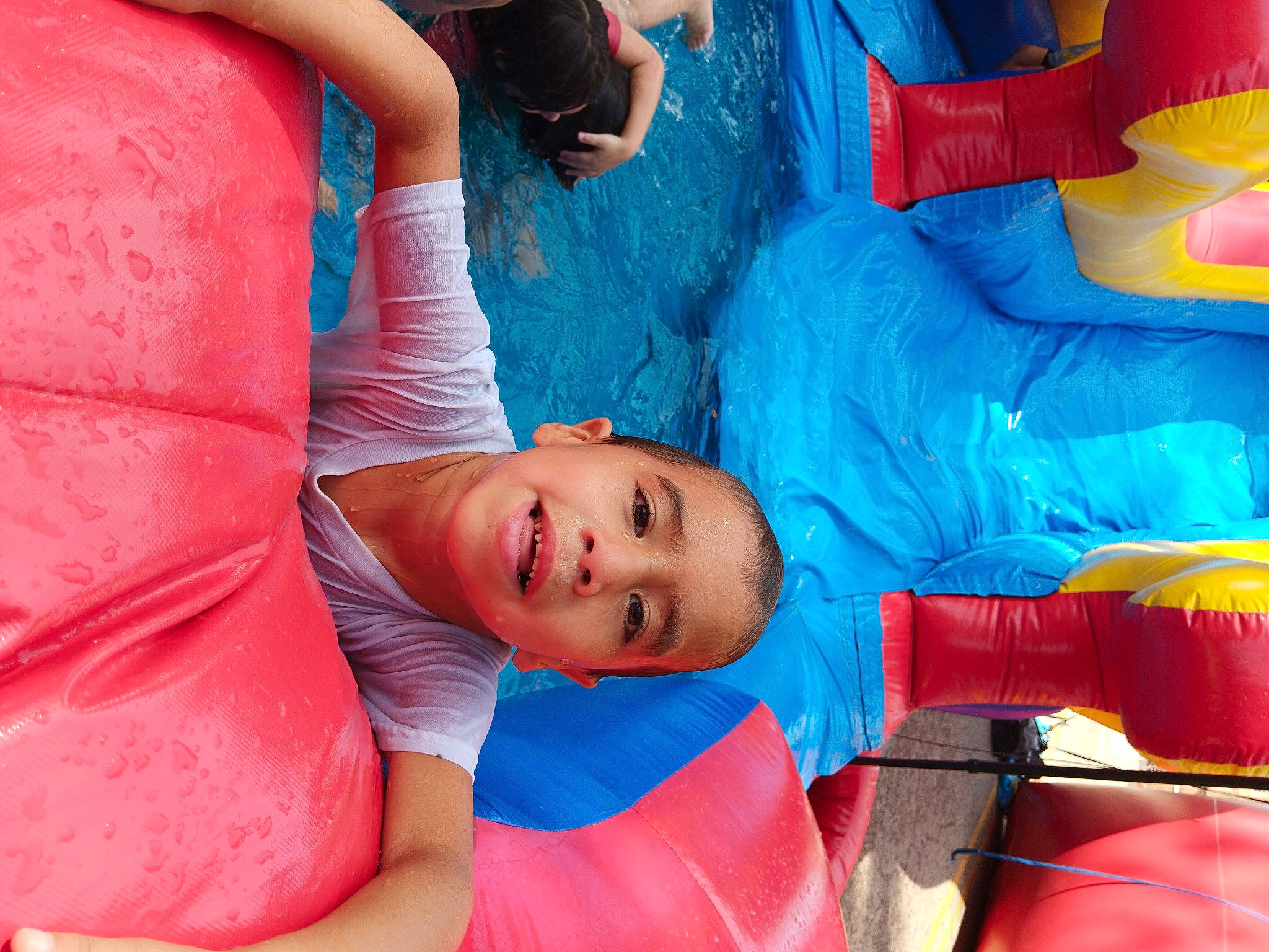 Joesph is registered to the contest to win money with this photo: azure, blue, child, elbow, electric_blue, fun, happy, inflatable, leisure, mouth, orange, person, pink, play, recreation, red, smile, t_shirt, textile, toddler