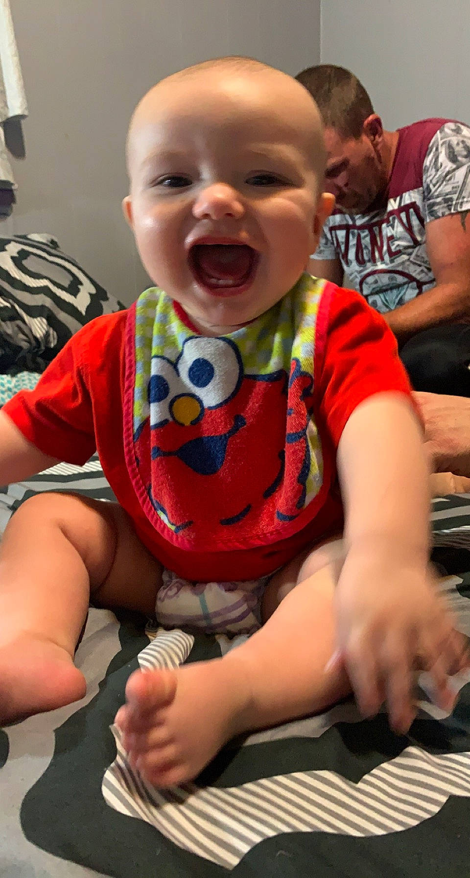 Jaylen is registered to the contest to win money with this photo: arm, baby_toddler_clothing, cheek, chin, clothing, eye, face, finger, hairstyle, happy, head, joint, mouth, nose, orange, organ, person, photograph, skin, sleeve