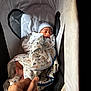 newborn, baby, sleeping, blanket, bassinet, hat, hand, infant, cozy, patterned_blanket, striped_blanket, indoors, soft_lighting, cute, resting, peaceful, tiny_feet, portrait, person, sleep