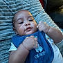 Kurrency joined the competition — help win amazing prizes! baby, infant, blue_bib, elephant_graphic, clothing, blanket, texture, fist, face, portrait, curious, indoor, skin, expression, cute, closeup, young_child, lying_down, soft_lighting, toddler