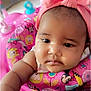 baby, child, pink_bow, headband, minnie_mouse, baby_walker, toy, colorful, indoor, closeup, infant, cute, chubby_cheeks, curious, face, arm, playful, young_child, person, portrait
