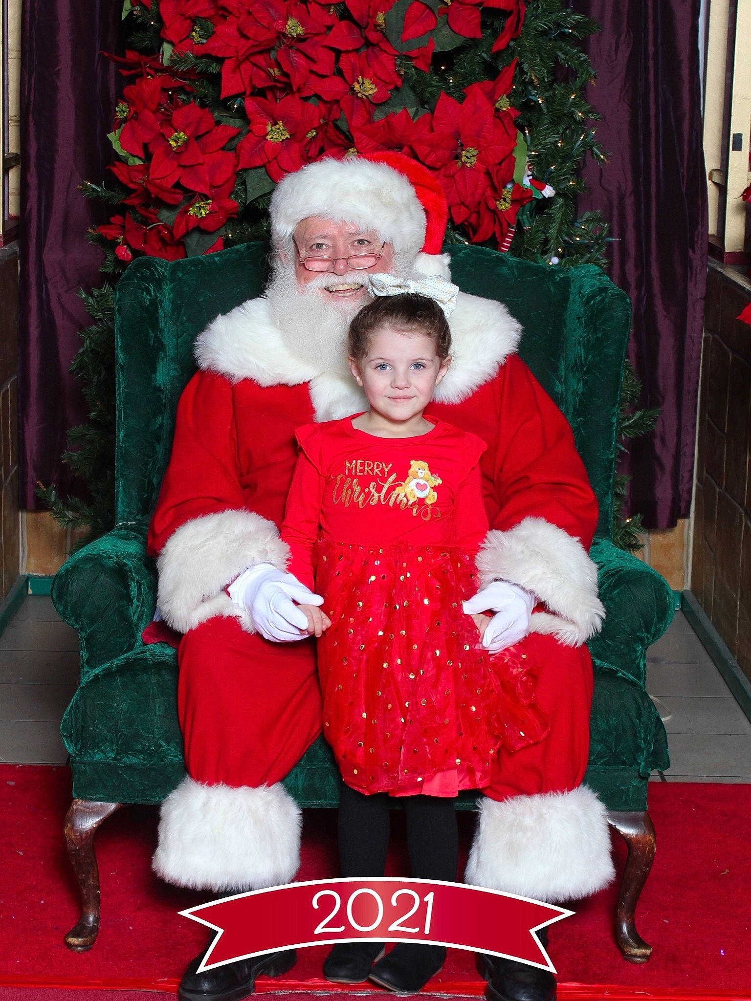 Trisha joined the competition — help win amazing prizes! christmas, christmas_decoration, christmas_eve, curtain, event, fun, happy, hat, headwear, holiday, interior_design, joy, lap, person, red, santa_claus, sitting, smile, toddler, tradition