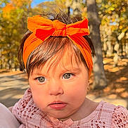 Zoe joined the competition — help win amazing prizes! baby, child, infant, portrait, face, eyes, bow, headband, pink_outfit, floral_pattern, dress, autumn, forest, trees, outdoor, sunlight, bokeh, closeup, looking_at_camera, adorable