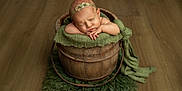 Letti joined the competition — help win amazing prizes! newborn, baby, sleeping, wooden_bucket, green_fabric, headband, infant, floor, cozy, portrait, soft_lighting, rustic, cute, resting, child, indoors, peaceful, decor, texture, photography