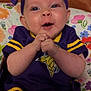 Letti joined the competition — help win amazing prizes! baby, child, purple_bow, sports_outfit, clapping_hands, smiling, blue_eyes, floral_cushion, happy, cute, infant, cheerful, portrait, sitting, indoor, headband, cheeks, small_hands, bright_colors, closeup