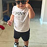 Noah joined the competition — help win amazing prizes! child, toddler, standing, sunglasses, fashion, portrait, indoors, shirt, shorts, sneakers, clothing, person, face, hair, hand, smiling, casual, floor, living_room, photography