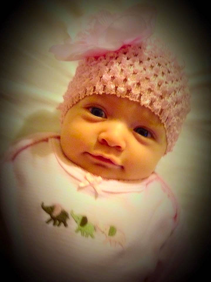 Delilah is registered to the contest to win money with this photo: baby, baby_toddler_clothing, cap, cheek, close_up, eye, eyebrow, eyelash, fashion_accessory, flash_photography, happy, headgear, iris, knit_cap, lip, nose, person, pink, skin, smile