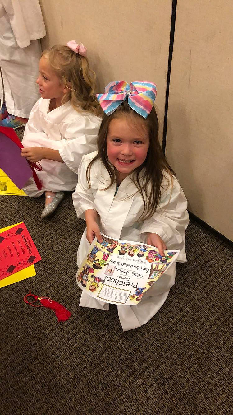 Delilah is registered to the contest to win money with this photo: child, christmas, costume, event, fashion_accessory, flooring, fun, happy, holiday, joy, laugh, pattern, person, play, recreation, sitting, sleeve, smile, sock, t_shirt