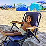 child, beach, sand, smile, chair, umbrella, sunny, vacation, relaxing, shorts, happy, outdoor, sea, summer, holiday, people, blue, sunlight, casual, fun