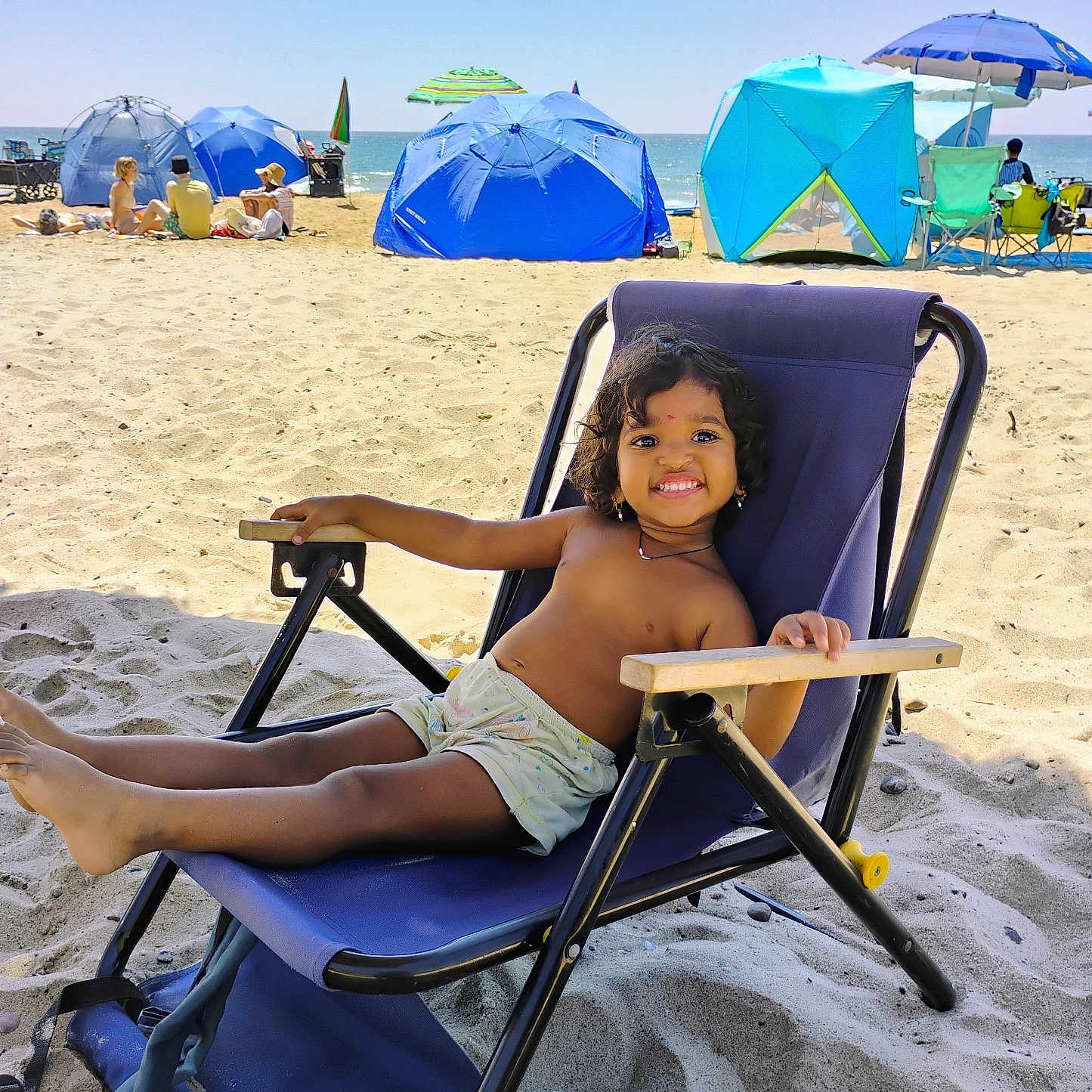 Ruthwika joined the competition — help win amazing prizes! beach, blue, casual, chair, child, fun, happy, holiday, outdoor, people, relaxing, sand, sea, shorts, smile, summer, sunlight, sunny, umbrella, vacation