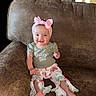 Elleauna is registered to the contest to win money with this photo: baby, girl, child, smiling, headband, pink_bow, green_shirt, floral_pants, ruffles, couch, brown_couch, sitting, happy, indoors, portrait, cute, infant, clothing, person, home