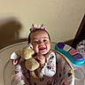 Elleauna joined the competition — help win amazing prizes! baby, child, infant, smiling, headband, stuffed_toy, toy, baby_seat, patterned_clothing, indoor, happy, face, person, play, colorful, pink, white, purple, cushion, seat