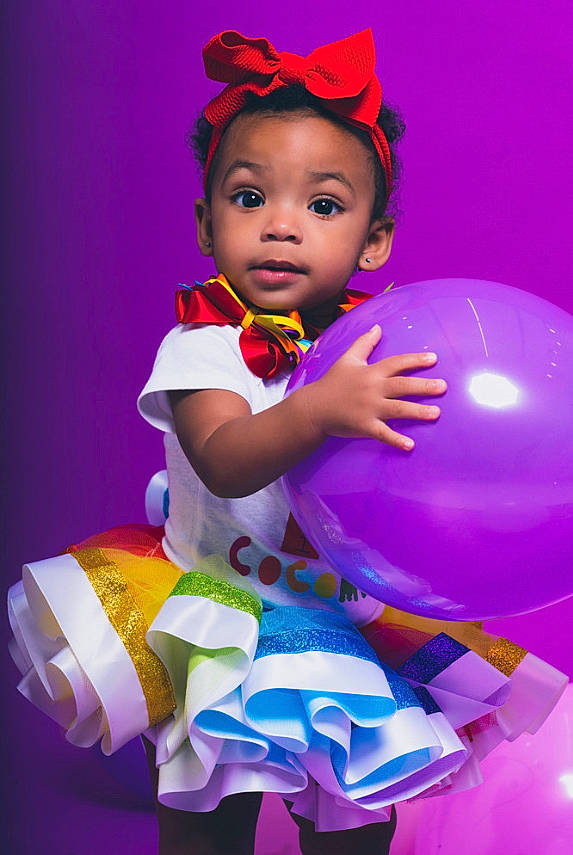 Leilahni is registered to the contest to win money with this photo: baby_toddler_clothing, balloon, beauty, child, electric_blue, entertainment, event, facial_expression, fashion_accessory, fictional_character, fun, happy, magenta, party, party_supply, person, pink, purple, toddler, toy