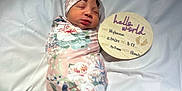 Mylianaa is registered to the contest to win money with this photo: newborn, baby, sleeping, swaddled, blanket, headband, floral, pink, white, wooden_plaque, birth_announcement, infant, cute, peaceful, portrait, indoors, soft_light, child, resting, newborn_photography