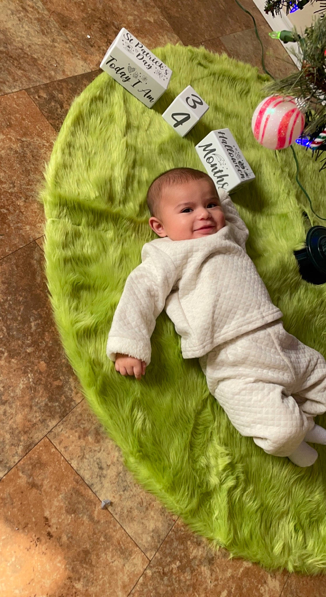 Avian is registered to the contest to win money with this photo: baby, baby_toddler_clothing, ball, child, comfort, fictional_character, flooring, fun, grass, happy, lawn, linens, pattern, people_in_nature, person, sleeve, smile, textile, toddler, tree