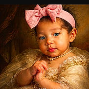 Ana is registered to the contest to win money with this photo: baby, child, portrait, headband, bow, pink, dress, lace, pearl_necklace, blue_eyes, curly_hair, cute, adorable, infant, hands, looking_at_camera, studio_lighting, golden, closeup, fashion