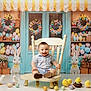 Liam is registered to the contest to win money with this photo: baby, child, chair, easter, eggs, chicks, bunny, flowers, tulips, wreath, pastel_colors, smiling, indoor, decorations, cute, festive, spring, vintage, props, portrait