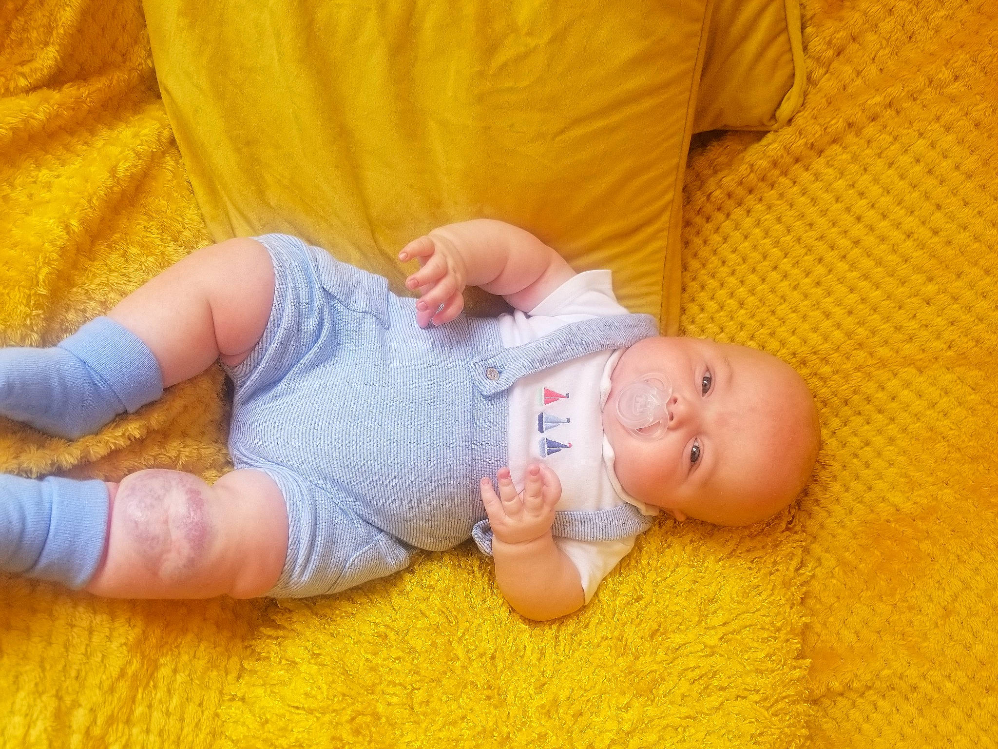 Parker joined the competition — help win amazing prizes! arm, baby, baby_toddler_clothing, cheek, comfort, eye, finger, flooring, gesture, hand, human_body, joint, leg, mammal, nose, orange, person, skin, thumb, wood