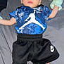 Ayson joined the competition — help win amazing prizes! baby, infant, child, clothing, blue_shirt, black_shorts, white_shoes, mittens, pacifier, lying_down, red_eye, flash, bed, gray_background, person, young_child, footwear, apparel, indoor, portrait
