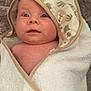 Evelyn joined the competition — help win amazing prizes! baby, towel, hood, lion_print, wrapped, face, skin, eyes, expression, soft_texture, fabric, floor, stone, cute, infant, child, portrait, indoors, warm, comfort
