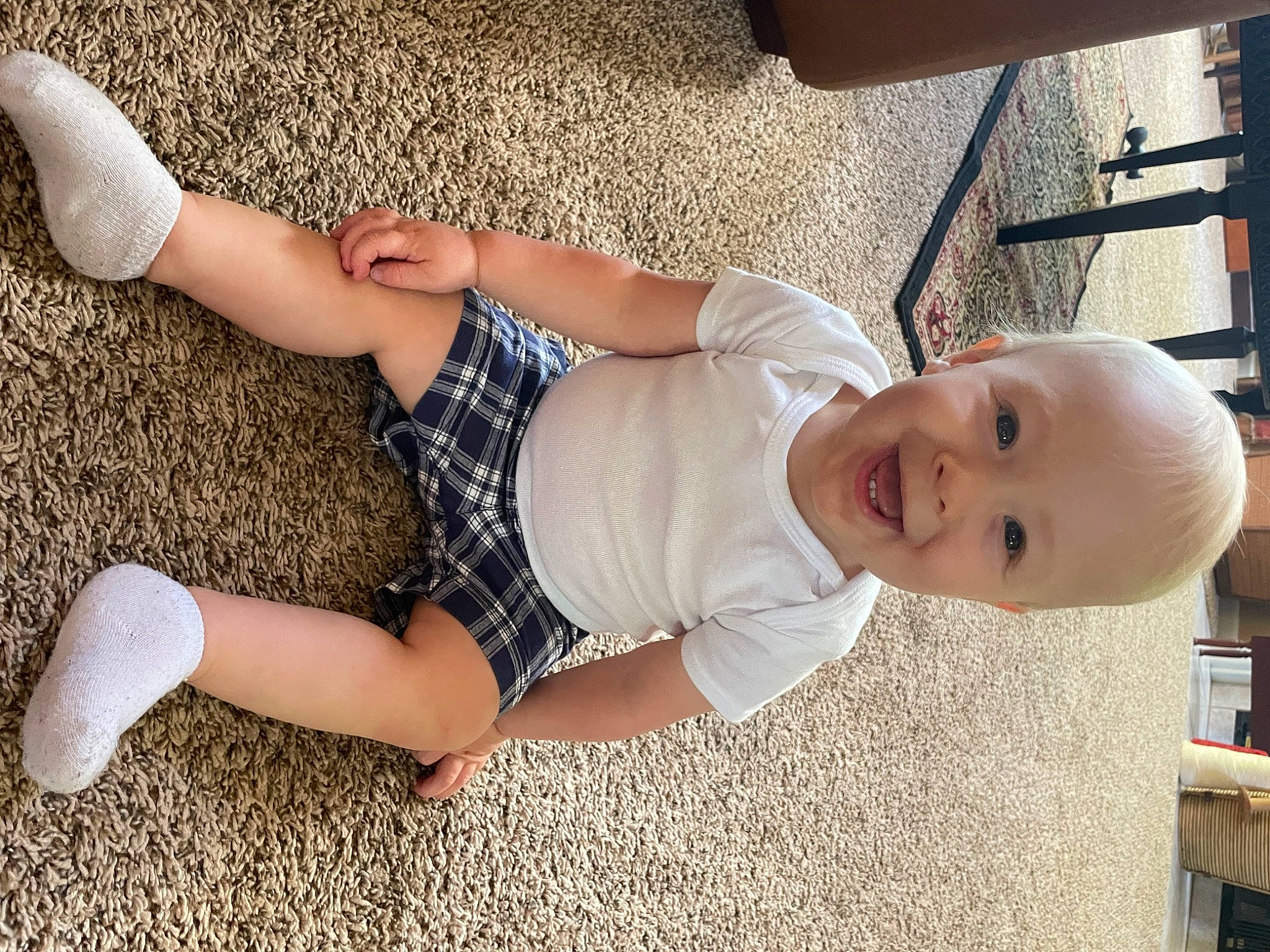 Liam joined the competition — help win amazing prizes! arm, baby, baby_toddler_clothing, child, comfort, dress, facial_expression, finger, fun, grass, hand, happy, human_body, joint, joy, knee, leg, person, skin, smile